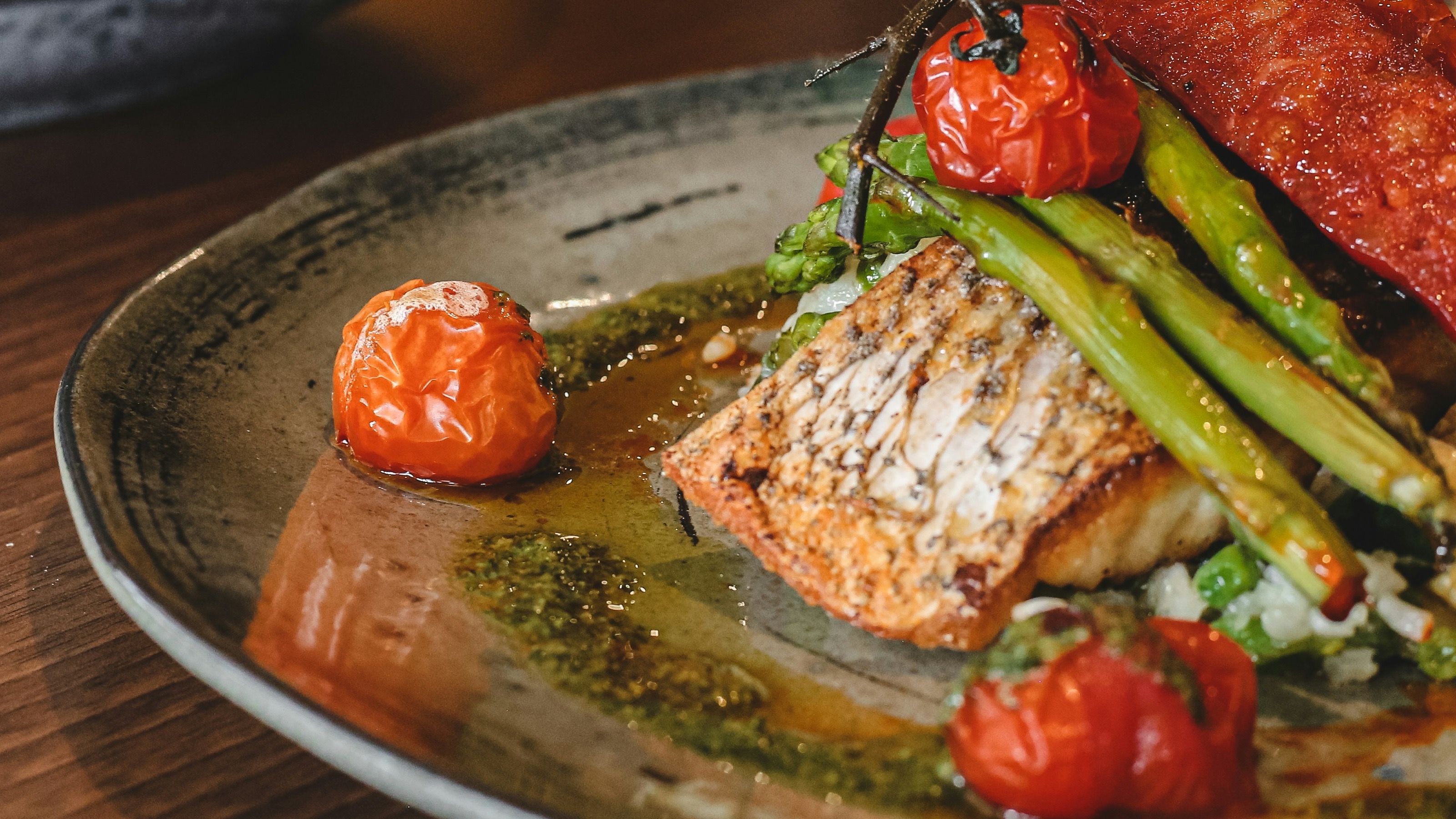Seared salmon fillet with asparagus and blistered tomatoes