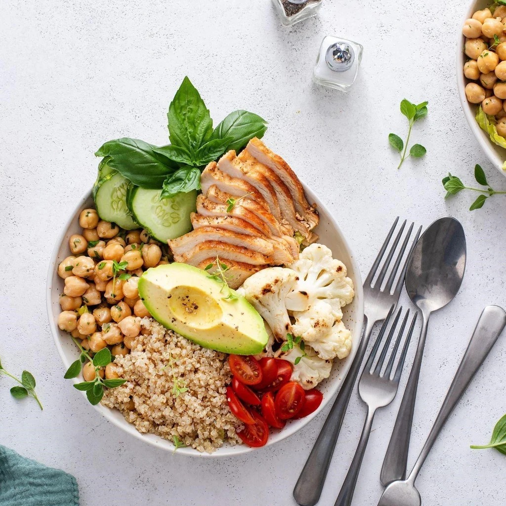 Mediterranean chicken quinoa bowl with chickpeas and avocado